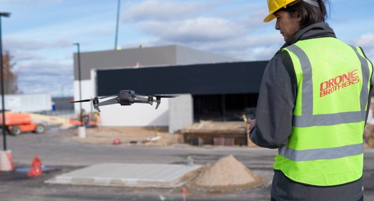 Drone Brothers pilot operating drone at construction site